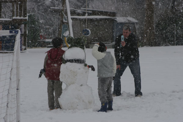 tim, the kids, and the snowman at honda chapel